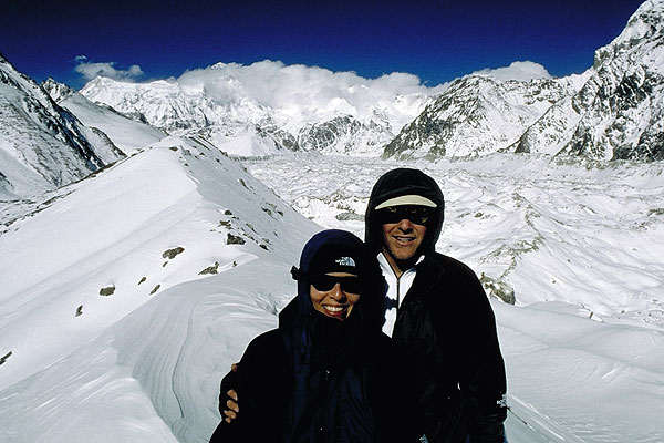 Ana and Justin in Gokyo Valley with glacier and Cho Oyu (8,188m). Temp -30, good to have The North Face gear.